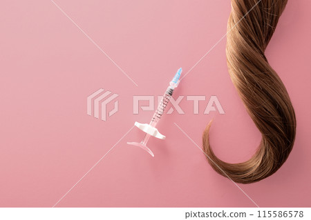 Hair treatment concept. Medical syringe and hair isolated on a white background 115586578