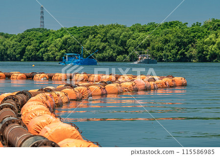 A boat mining gravel on the Yodo River 115586985