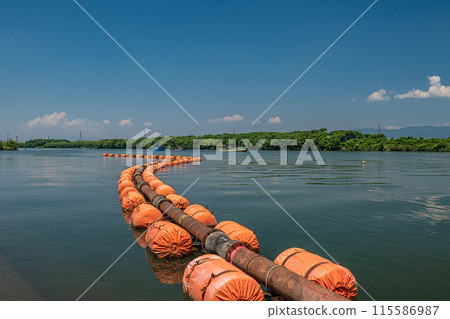 A boat mining gravel on the Yodo River 115586987