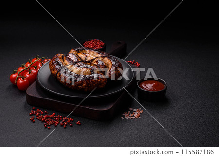 Delicious grilled sausage in the form of a ring with salt, spices 115587186