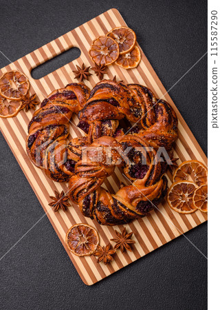 Delicious fresh baked bun with poppy seeds and berries Delicious fresh baked bun with poppy seeds and berries 115587290