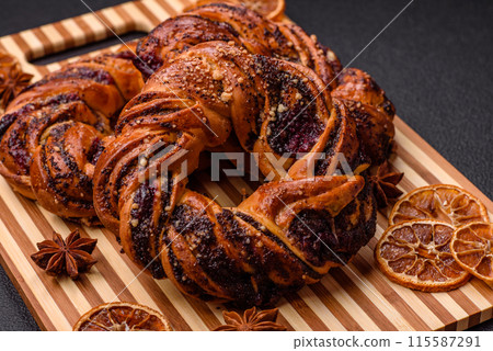 Delicious fresh baked bun with poppy seeds and berries 115587291