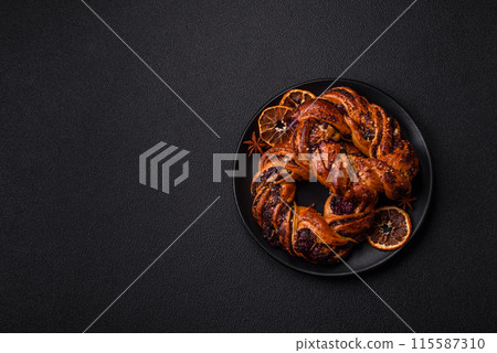 Delicious fresh baked bun with poppy seeds and berries 115587310