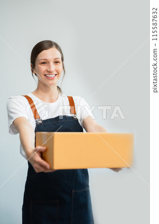 woman holding parcels box and looking to camera, isolated on white background. woman holding parcels box and looking to camera, isolated on white background. 115587632