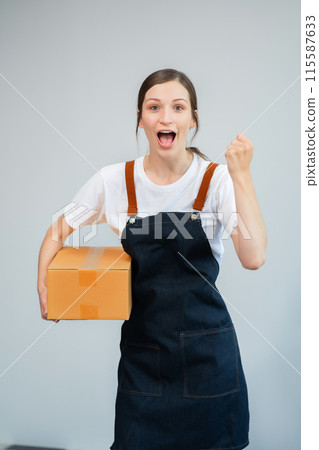 woman holding parcels box and looking to camera, isolated on white background. woman holding parcels box and looking to camera, isolated on white background. 115587633