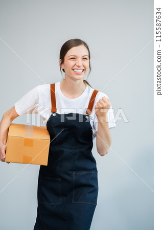 woman holding parcels box and looking to camera, isolated on white background. woman holding parcels box and looking to camera, isolated on white background. 115587634