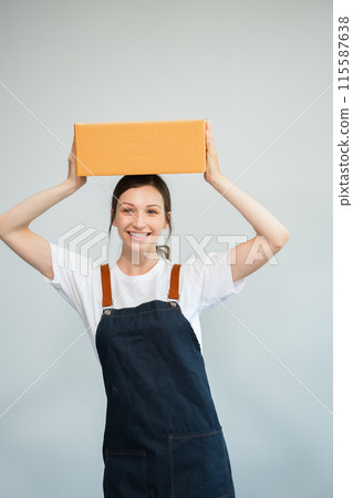 woman holding parcels box and looking to camera, isolated on white background. woman holding parcels box and looking to camera, isolated on white background. 115587638