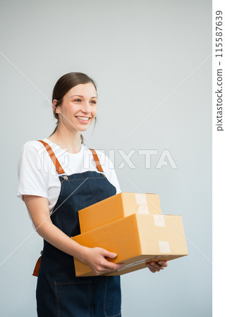 woman holding parcels box and looking to camera, isolated on white background. woman holding parcels box and looking to camera, isolated on white background. 115587639