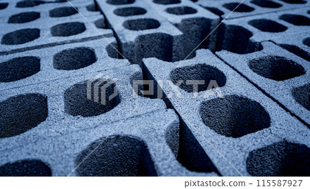 Concrete blocks with holes stacked on top of each other 115587927