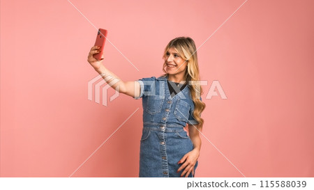 Cheerful transgender woman taking selfie through smartphone Cheerful transgender woman taking selfie through smartphone 115588039