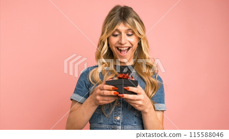 Excited transgender woman opening small gift box against pink background Excited transgender woman opening small gift box against pink background 115588046