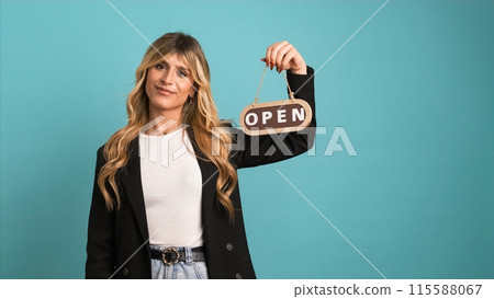 Excited transgender businesswoman looking at camera while showing open sign Excited transgender businesswoman looking at camera while showing open sign 115588067