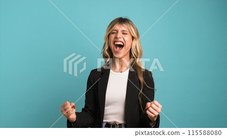 Successful transgender businesswoman with clenched fists celebrating victory 115588080