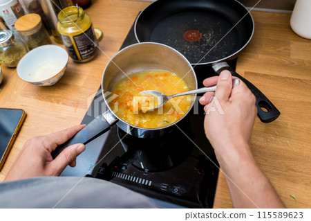 Chef at the kitchen preparing lentils soup with cauliflower and broccoli Chef at the kitchen preparing lentils soup with cauliflower and broccoli 115589623