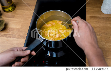 Chef at the kitchen preparing green curry with herbs and rice Chef at the kitchen preparing green curry with herbs and rice 115589653