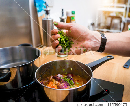 Chef at the kitchen preparing massaman curry with sweet potato and many spices 115590475