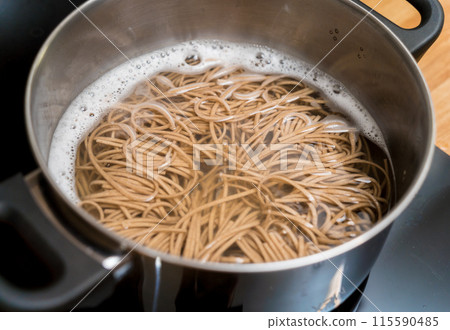 Chef at the kitchen preparing japanese buckwheat pasta with lentils 115590485