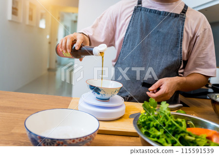 Chef at the kitchen preparing spicy glass noodle salad Chef at the kitchen preparing spicy glass noodle salad 115591539