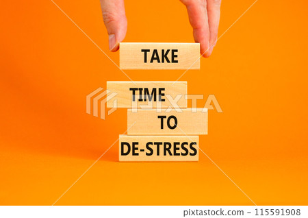 Take time to de-stress symbol. Concept words Take time to de-stress on wooden blocks. Beautiful orange table orange background. Psychological business and take time to de-stress concept. Copy space. 115591908