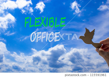 Flexible office symbol. Concept words Flexible office on beautiful sky. Beautiful blue sky cloud background. Businessman hand with wooden bird. Business Flexible office concept. Copy space. 115591961