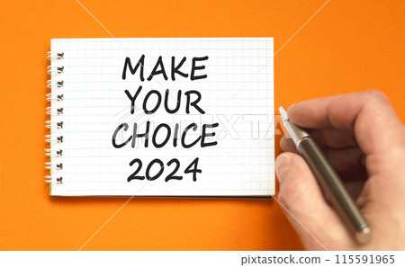 Make your choice 2024 symbol. Concept words Make your choice 2024 on beautiful white note. Beautiful orange background. Voter hand. Business Make your choice 2024 concept. Copy space Make your choice 2024 symbol. Concept words Make your choice 2024 on beautiful white note. Beautiful orange background. Voter hand. Business Make your choice 2024 concept. Copy space 115591965