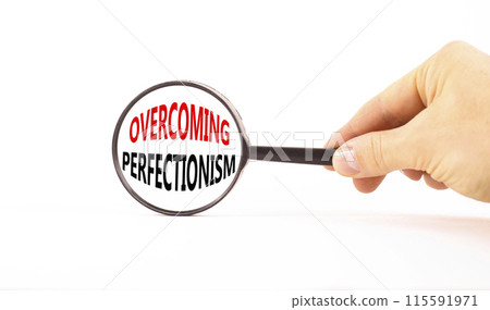 Overcoming perfectionism symbol. Concept words Overcoming perfectionism in magnifying glass. Beautiful white paper background. Businessman hand. Business Overcoming perfectionism concept. Copy space. Overcoming perfectionism symbol. Concept words Overcoming perfectionism in magnifying glass. Beautiful white paper background. Businessman hand. Business Overcoming perfectionism concept. Copy space. 115591971