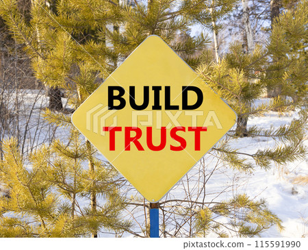 Build trust symbol. Concept words Build trust on beautiful yellow road sign. Beautiful forest snow blue sky background. Business and build trust concept, copy space. Build trust symbol. Concept words Build trust on beautiful yellow road sign. Beautiful forest snow blue sky background. Business and build trust concept, copy space. 115591990