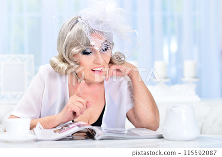 Portrait of happy senior woman posing at home Portrait of happy senior woman posing at home 115592087