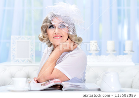 Portrait of happy senior woman posing at home Portrait of happy senior woman posing at home 115592089