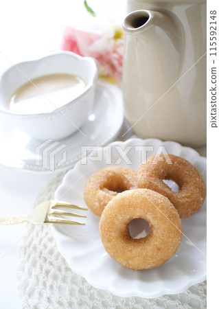 Tea time with mini sugar donuts 115592148
