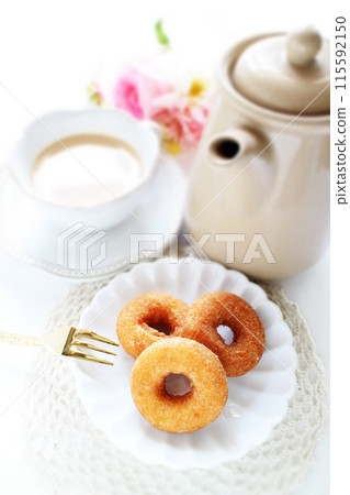 Tea time with mini sugar donuts 115592150