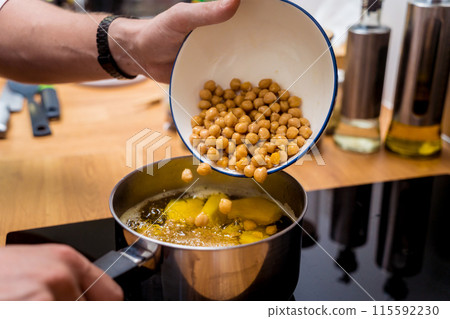 Chef at the kitchen preparing chickpea porridge with ginger 115592230