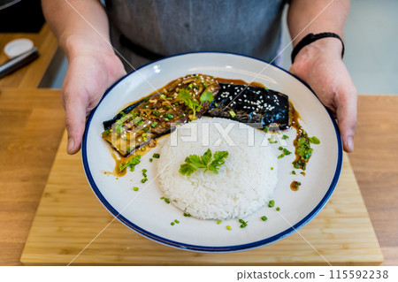 Delicious grilled eggplants with garlic on the white plate 115592238