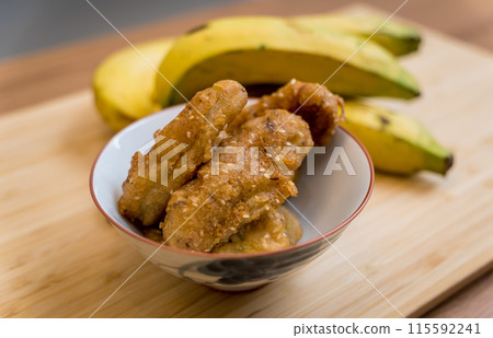 Crispy fried bananas in the small white bowl 115592241
