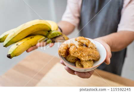 Crispy fried bananas in the small white bowl Crispy fried bananas in the small white bowl 115592245