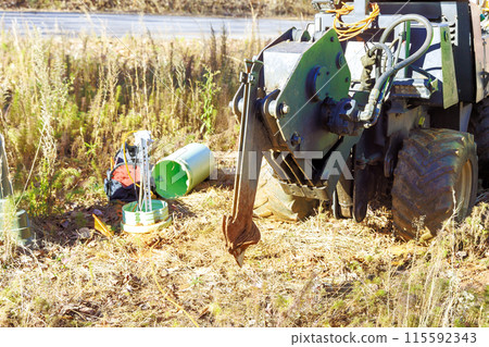 Fiber optic cables laid with help of trencher cable plow tractor Fiber optic cables laid with help of trencher cable plow tractor 115592343