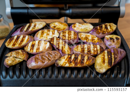 Delicious grilled eggplants with garlic on the electric grill 115593157