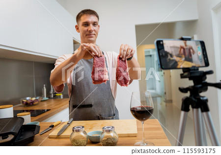 The chef is broadcasting live from workshop how to prepare a beef steaks on the electric grill The chef is broadcasting live from workshop how to prepare a beef steaks on the electric grill 115593175