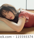 Woman lying on bed 115593374