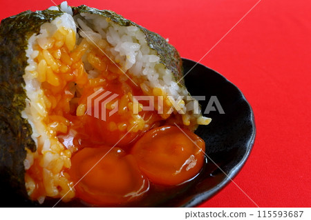 Egg yolk rice ball on red background Egg yolk rice ball on red background 115593687