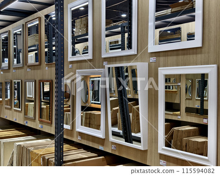 A warehouse packed with numerous mirrors and boxes A warehouse packed with numerous mirrors and boxes 115594082