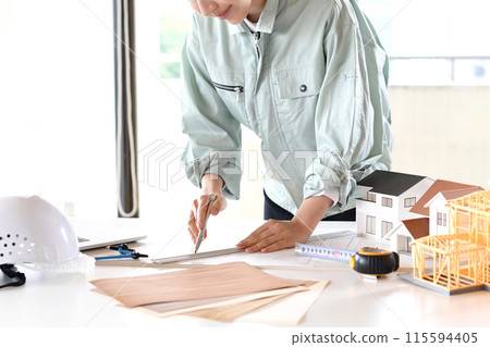 Asian woman in work clothes designing architecture Asian woman in work clothes designing architecture 115594405