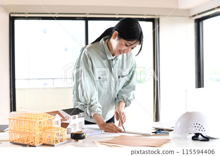 Asian woman in work clothes designing architecture 115594406