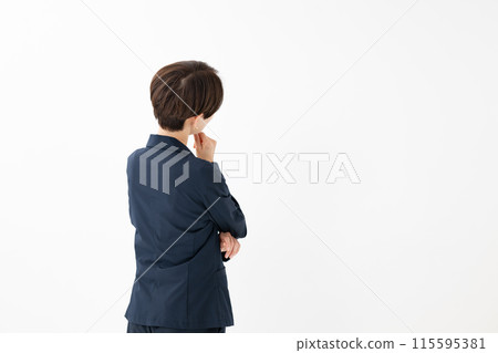 A woman in a suit thinking (rear view) A woman in a suit thinking (rear view) 115595381