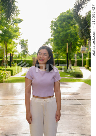 Portrait of beautiful Asian woman outdoor in park during summer 115595427