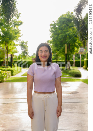 Portrait of beautiful Asian woman outdoor in park during summer Portrait of beautiful Asian woman outdoor in park during summer 115595428