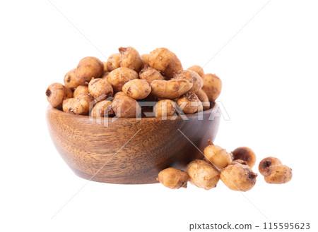 Tiger nuts in wooden bowl, isolated on white background. Pile of chufa nuts, earth almond or chufa sedge. Cyperus esculentus. 115595623