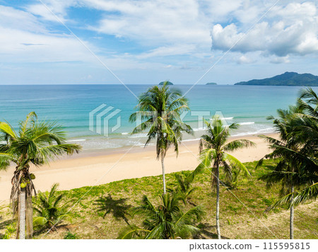 Duli Beach with coconut trees and ocean waves over the sands. El Nido, Philippines. Duli Beach with coconut trees and ocean waves over the sands. El Nido, Philippines. 115595815