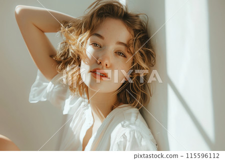 Elegant Woman Posing In Casual White Attire Against A White Backdrop 115596112