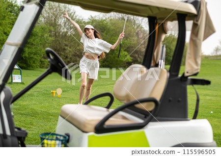 Active woman posing with golf gear by the vehicle outside Active woman posing with golf gear by the vehicle outside 115596505